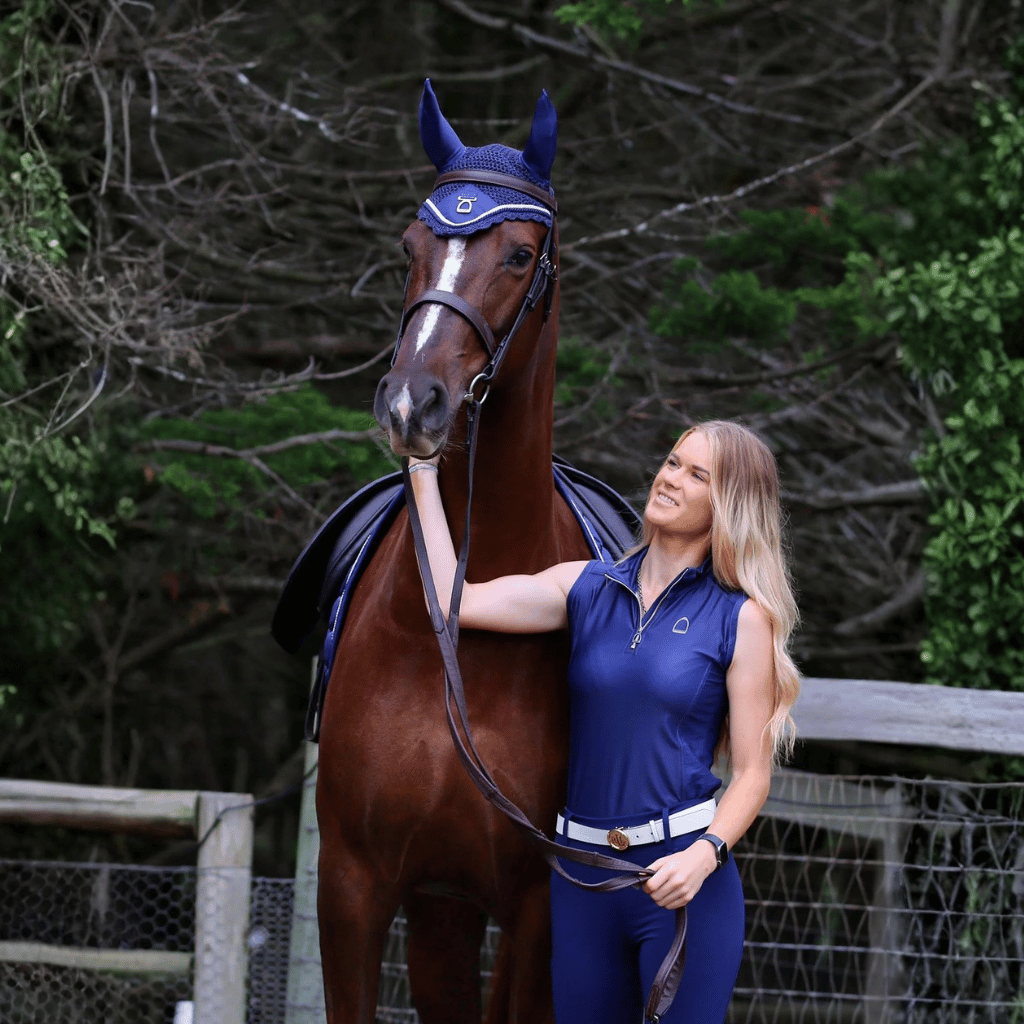 Female rider standing with chestnut coloured horse wearing the Kindred Collection from Regent Equestrian